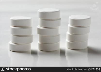 a pile of tablets on a white table