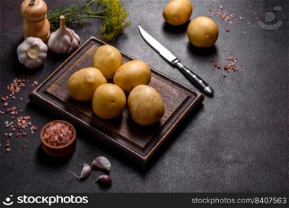A pile of young potatoes on the table. The benefits of vegetables. Harvest and natural products. A pile of young potatoes on the table. The benefits of vegetables