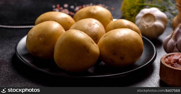 A pile of young potatoes on the table. The benefits of vegetables. Harvest and natural products. A pile of young potatoes on the table. The benefits of vegetables