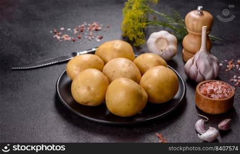 A pile of young potatoes on the table. The benefits of vegetables. Harvest and natural products. A pile of young potatoes on the table. The benefits of vegetables