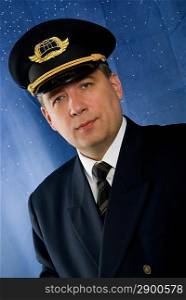 A pilot in uniform on blue background.