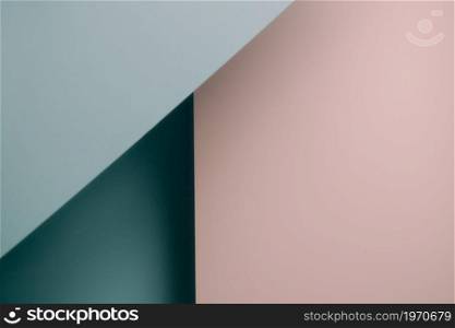 A pink and blue blue pastel flat lay background with sharp layers and shadows with copy space gender