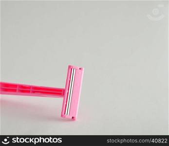 A pink disposable razor isolated on a white background
