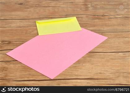 A pink paper and a yellow envelope