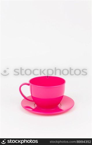 a pink plastic cup with saucer on white background. pink plastic cup with saucer on white background