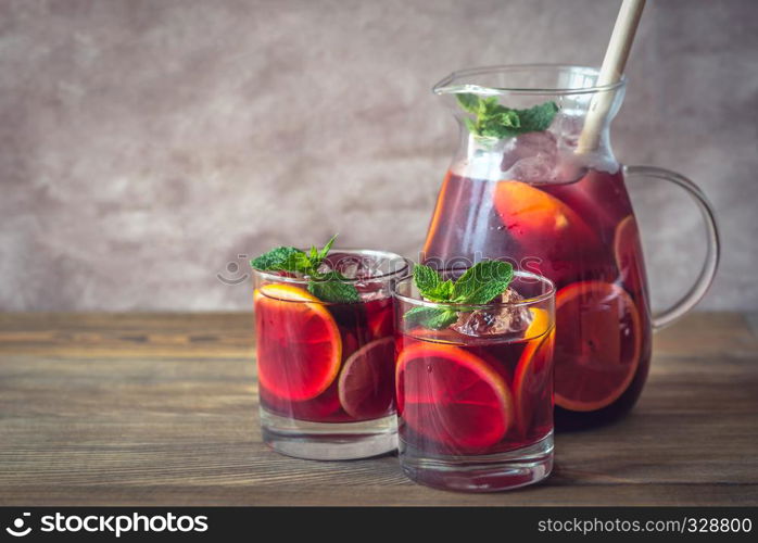 A pitcher and two glasses with Spanish fruit Sangria