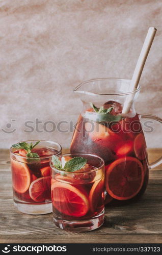 A pitcher and two glasses with Spanish fruit Sangria