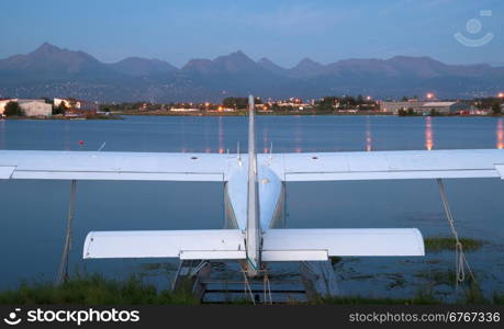 A plane sits waiting for the next chance to be of service as darkness falls on Anchorage