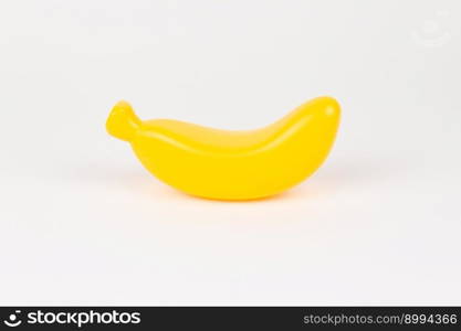 a plastic toy banana on a white background. plastic toy banana on a white background