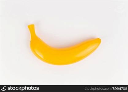 a plastic toy banana on a white background. plastic toy banana on a white background