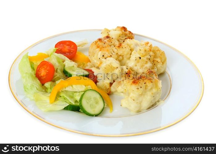 A plate of cauliflower cheese served with a salad of lettuce, cucumber, tomato and capsicum, a traditional English dish.