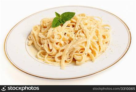 A plate of Fettucine all&acute;Alfredo, pasta in a butter, cream and parmesan sauce, garnished with a sprig of basil and sprinkled with grated cheese