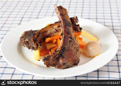 A plate of lamb chops flavoured with herbs and then fried on a bed of oven baked acorn squash, parsnip, onion and carrot