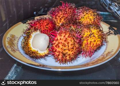 A plate of spiky rambutan fruits