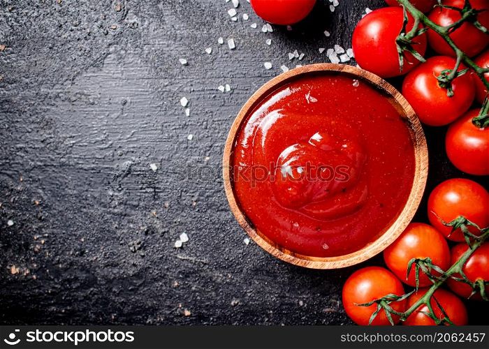 A plate of tomato sauce with pieces of salt. On a black background. High quality photo. A plate of tomato sauce with pieces of salt.