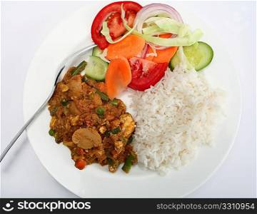 A plate of vegetable shabnam vegetarian mushroom curry with rice and salad