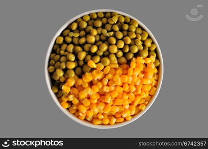 a plate with corn and peas, isolated, on a grey background