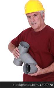 A plumber holding parts