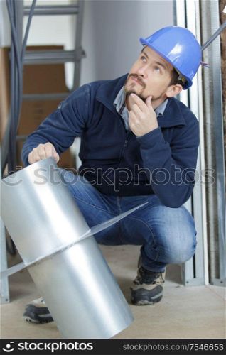 a plumber is repairing a pipe