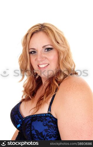 A plus size blond woman in a blue and black corset looking smilinginto the camera, isolated for white background.
