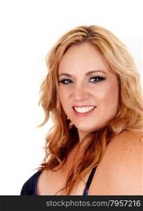 A plus size blond woman in a blue and black corset looking smilinginto the camera, isolated for white background.