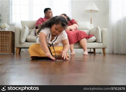 A plus size family with a father wearing a prosthetic leg, During rest time allow daughter to play games on tablet in the living room of the house.