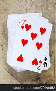 A poker card deck with seven of hearts on the top