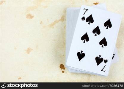 A poker card deck with seven of spades on the top