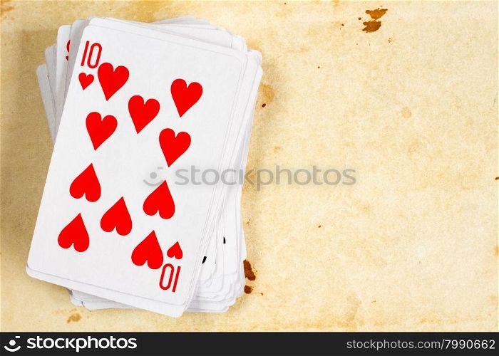 A poker card deck with ten of hearts on the top