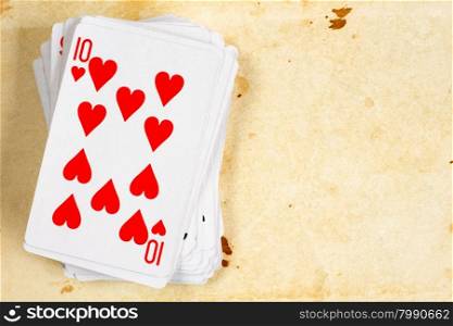 A poker card deck with ten of hearts on the top
