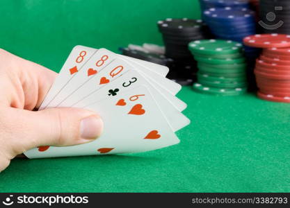 A poker hand with one pair - a poker player looking at his cards