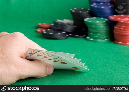 A poker hand with one pair - a poker player looking at his cards