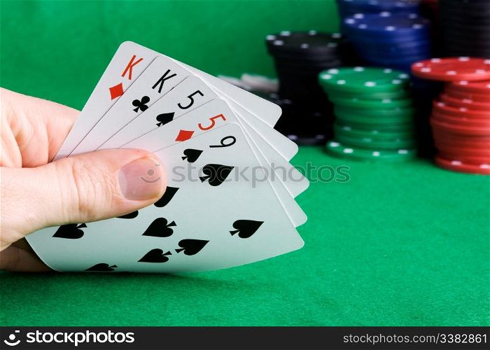 A poker hand with two pair and chips in the background