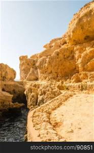 A pool of natural sea water between sandstone cliffs at Algar Seco. Carvoeiro Algarve Portugal.