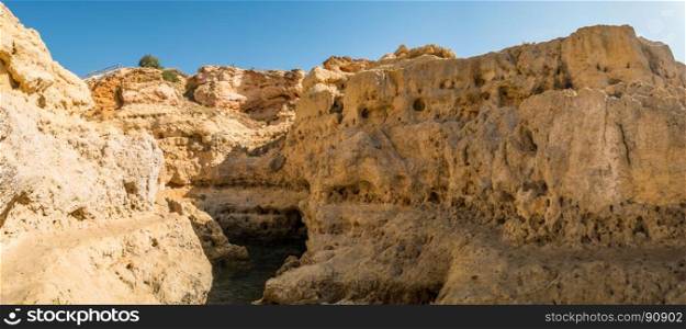 A pool of natural sea water between sandstone cliffs at Algar Seco. Carvoeiro Algarve Portugal.