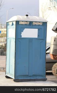 A portable toilet near a construction site