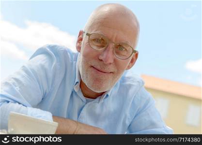 a portrait a senior man with glasses