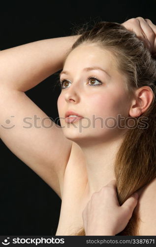 A portrait close up of the beautiful girl with long hair. On a black background