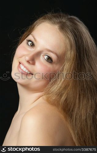 A portrait close up of the beautiful girl with long hair. On a black background