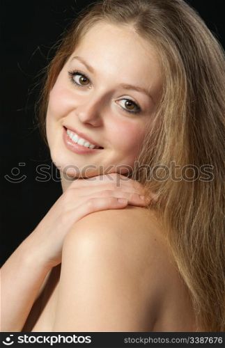 A portrait close up of the beautiful girl with long hair. On a black background