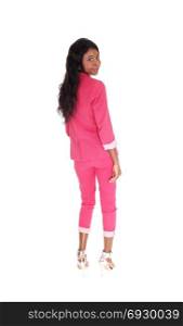 A portrait image of a African American woman in a pinksuit, smiling, from the back, isolated for white background