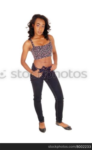 A portrait image of a African American women in a colorful top andblue jeans standing, isolated for white background.