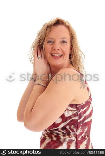 A portrait image of a happy blond woman standing with her hands on her head, smiling, isolated for white background.