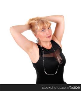 A portrait image of a pretty blond woman in a black dress with her hands on her head, isolated for white background.