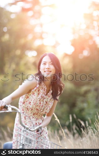 A portrait of a beautiful asian woman with a bicycle outdoor