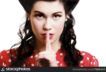 a portrait of a beautiful brunette with a finger on her lips showing to keep silence, hush