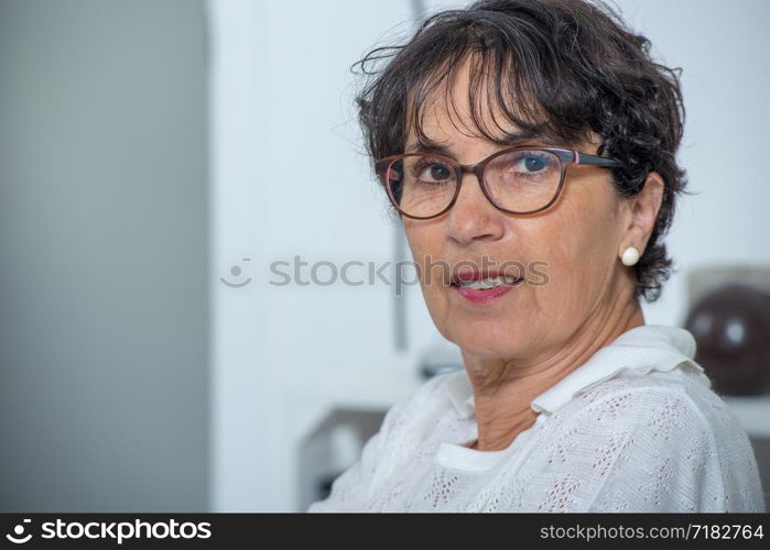 a portrait of a beautiful mature woman at home