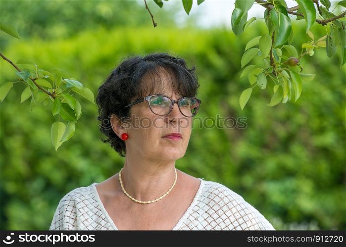 a portrait of a beautiful mature woman in the garden