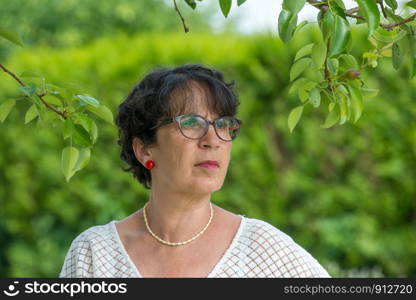 a portrait of a beautiful mature woman in the garden