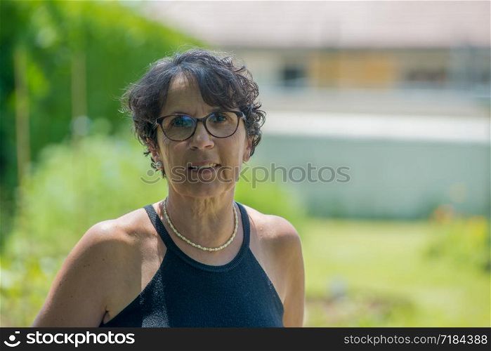 a portrait of a beautiful senior woman in the garden